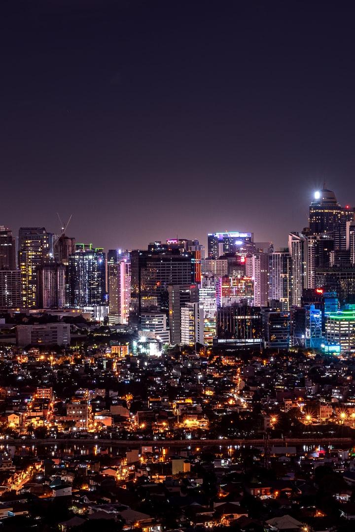 city with high rise buildings during night time